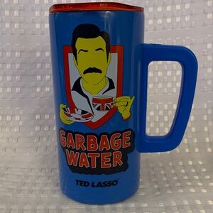 Ted Lasso Stainless steel Blue Travel Mug, holds 15 ounces, 6 inches tall.